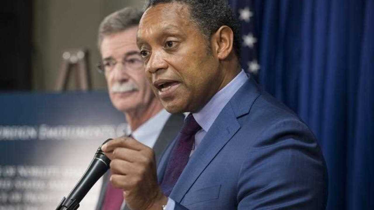 District of Columbia Attorney-General Karl Racine (R) and Maryland Attorney-General Brian Frosh (L) announce a lawsuit against US President Donald Trump.