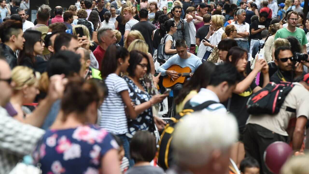 Huge crowds fill Pitt Street Mall and the CBD shopping district as they purchase their last minute christmas gifts on Christmas Eve in Sydney, Wednesday, Dec. 24, 2014. (AAP Image/Dean Lewins) NO ARCHIVING