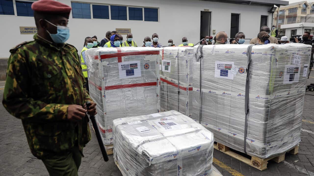 A Kenyan soldier guards a consignment of 182,000 AstraZeneca.