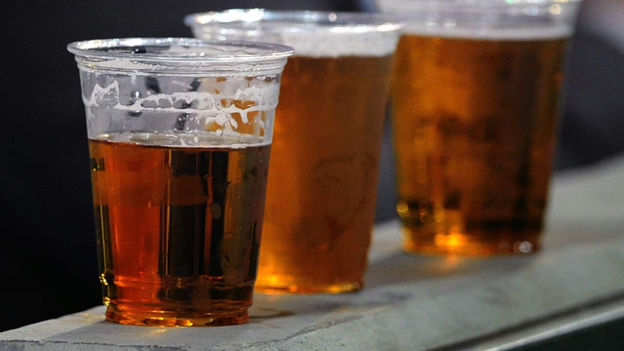 People drinking beer at a sporting venue in Melbourne