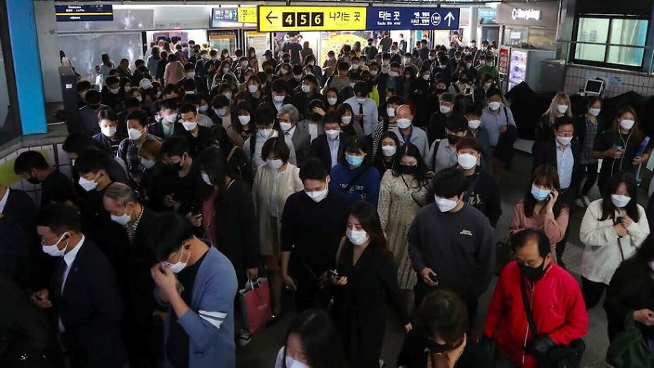 Commuters change trains in the morning rush hour at a subway station in Seoul, South Korea on Monday.
