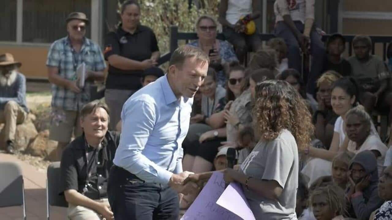 Tony Abbott is welcomed to a local school in Pukatja, South Australia.