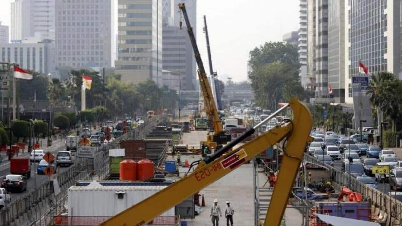 Workers using heavy machinery are seen constructing the new MRT line in central Jakarta. July 2, 2015.