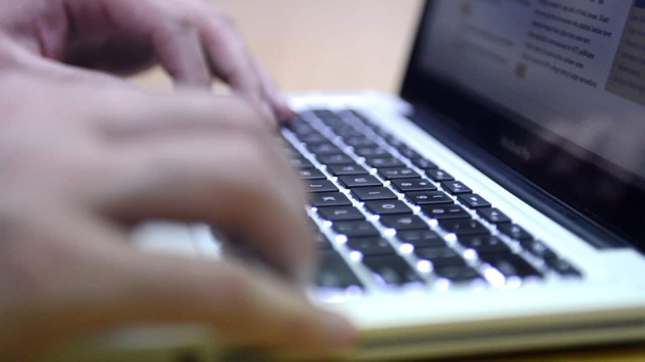 A man uses a laptop computer in Brisbane