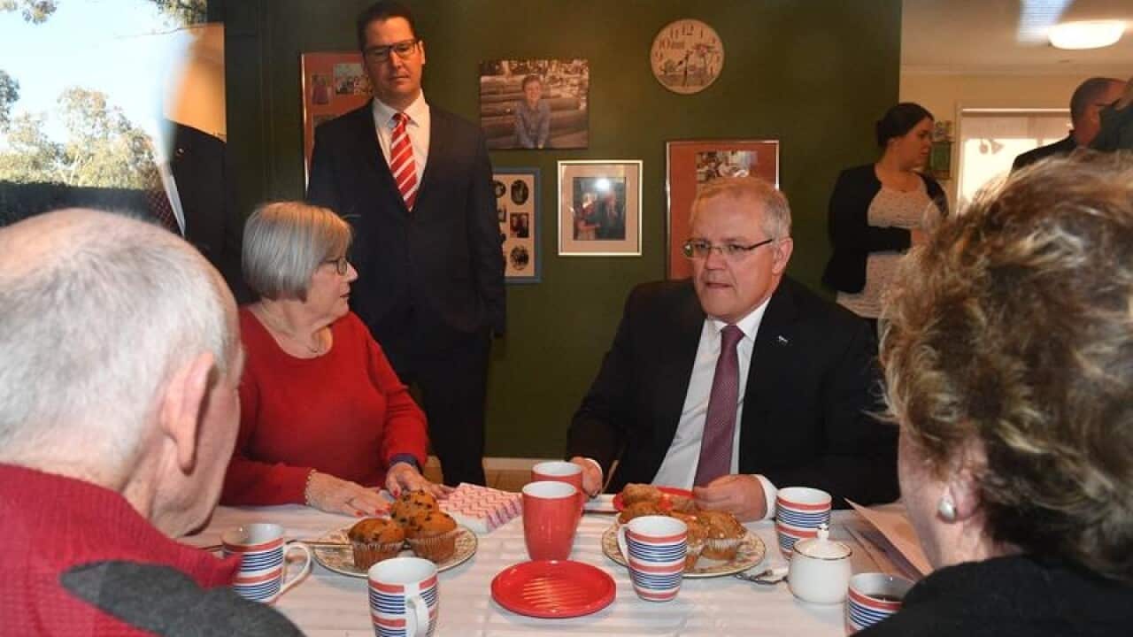 A file image of PM Scott Morrison visiting an elderly couple