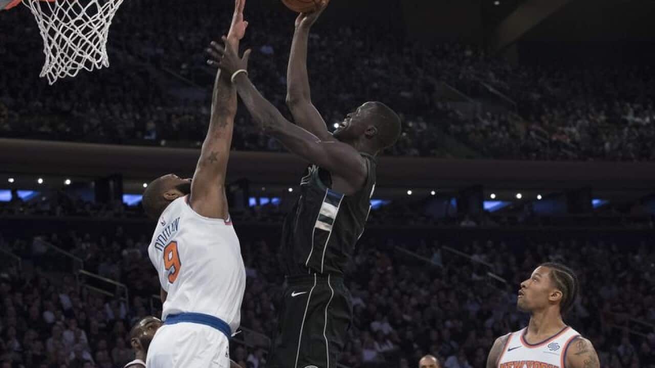 Milwaukee Bucks center Thon Maker, center. goes to the basket.