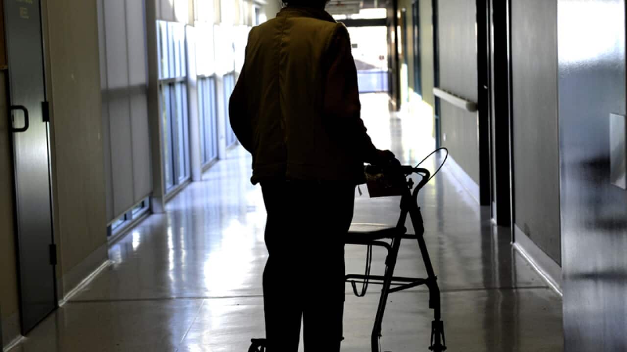 A woman uses a walker to assist her mobility in Canberra