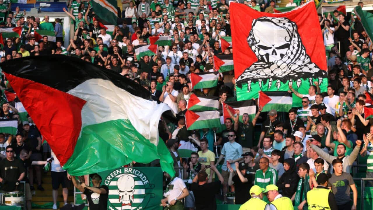 Celtic fans hold up Palestine flags