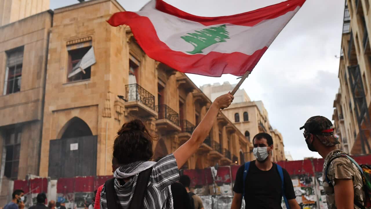 People hold a protest outside the offices of Lebanon's Parliament.