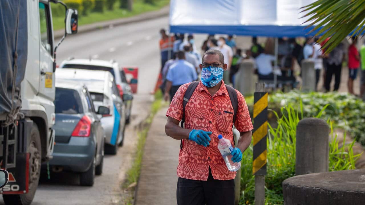 Security officers in Suva check cars along a road in April.