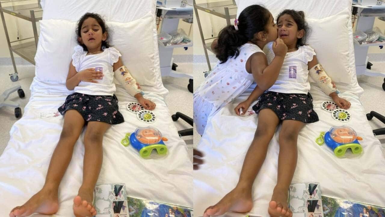 Tharnicaa and her older sister Kopika in hospital on Christmas Island before her medical evacuation.