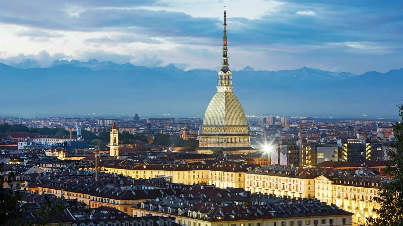 Elevated view of the 'Mole Antonelliana', the cityscape of Turin (Torino) and the Alps at dusk