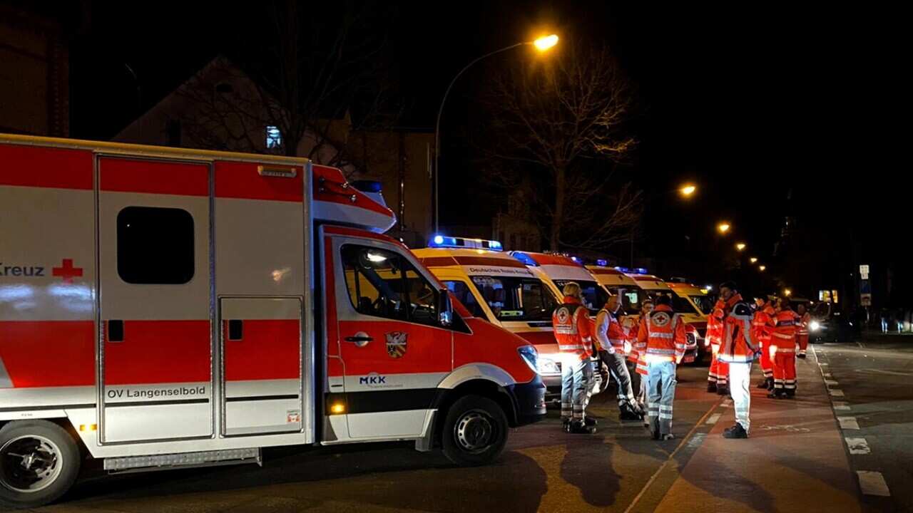Ambulances and paramedics at the crime scene after a shooting in Hanau near Frankfurt
