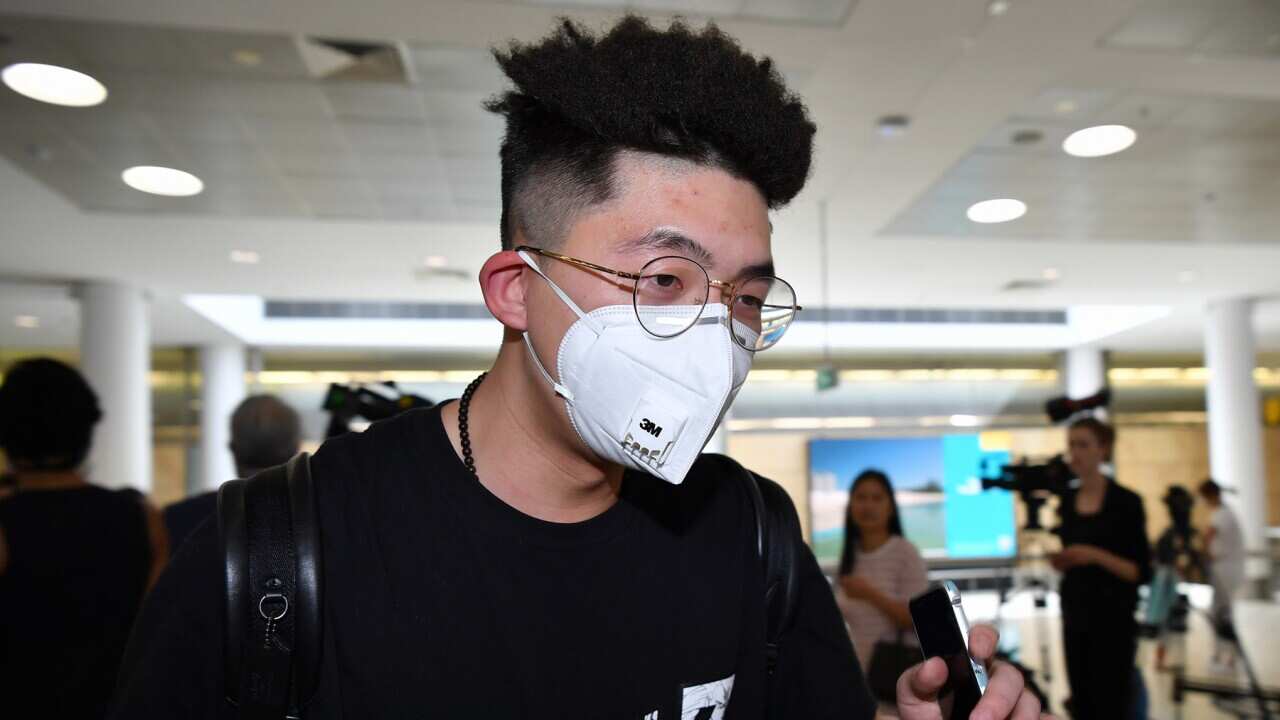 A passenger wearing a protective mask on arrival at Sydney International Airport