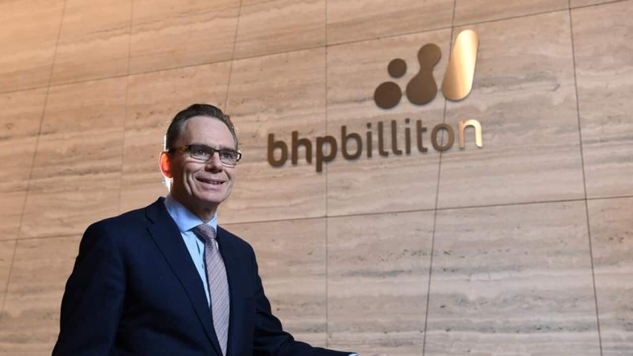 BHP CEO Andrew Mackenzie in front of BHP Billiton signage