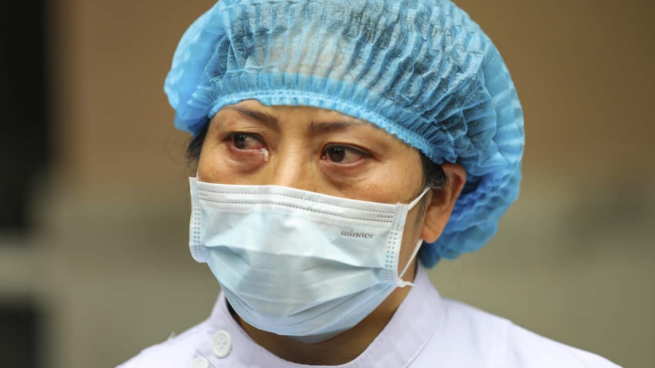 A nurse tears up as she talks about the situation in Jinyintan Hospital, designated for critical coronavirus patients in Wuhan