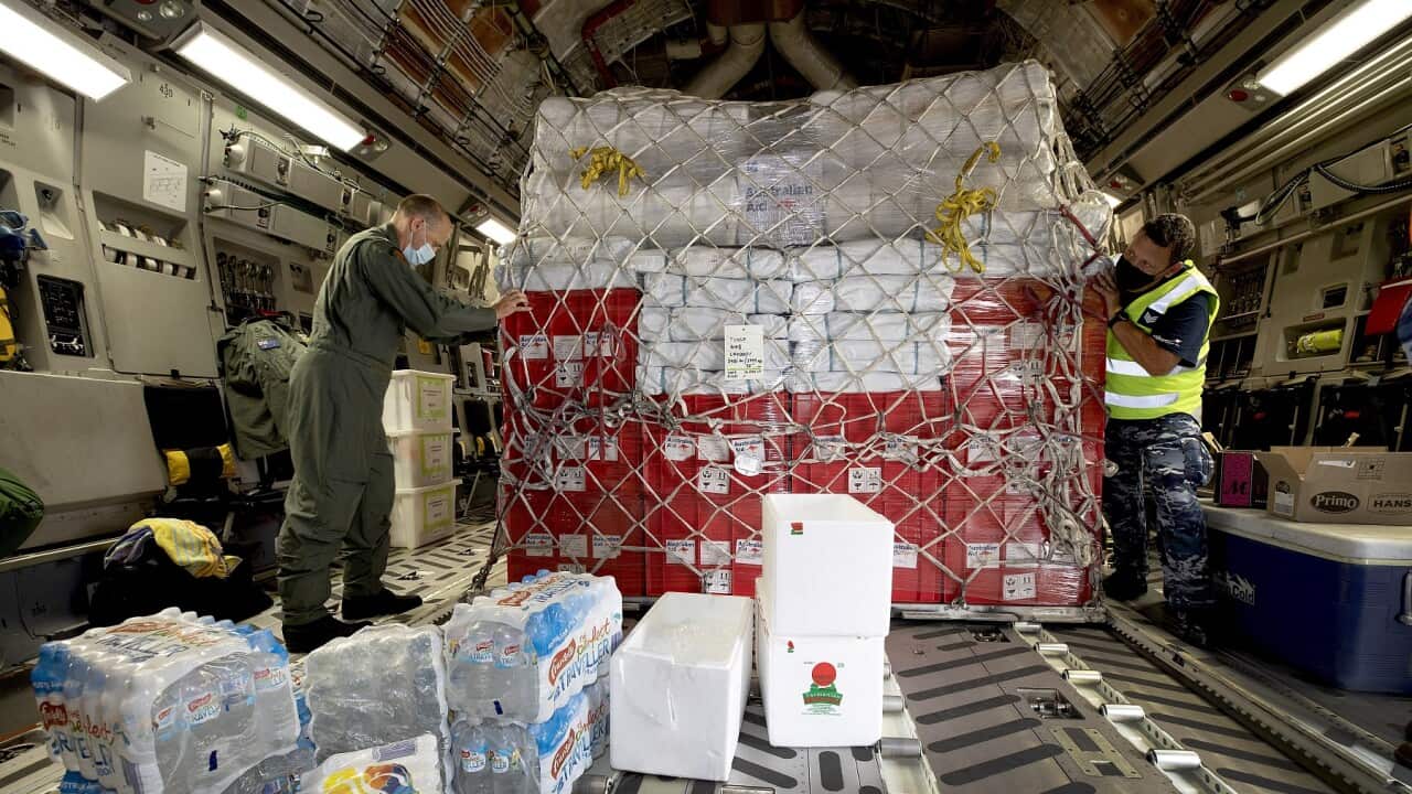 A pallet of goods in the back of a transport plane