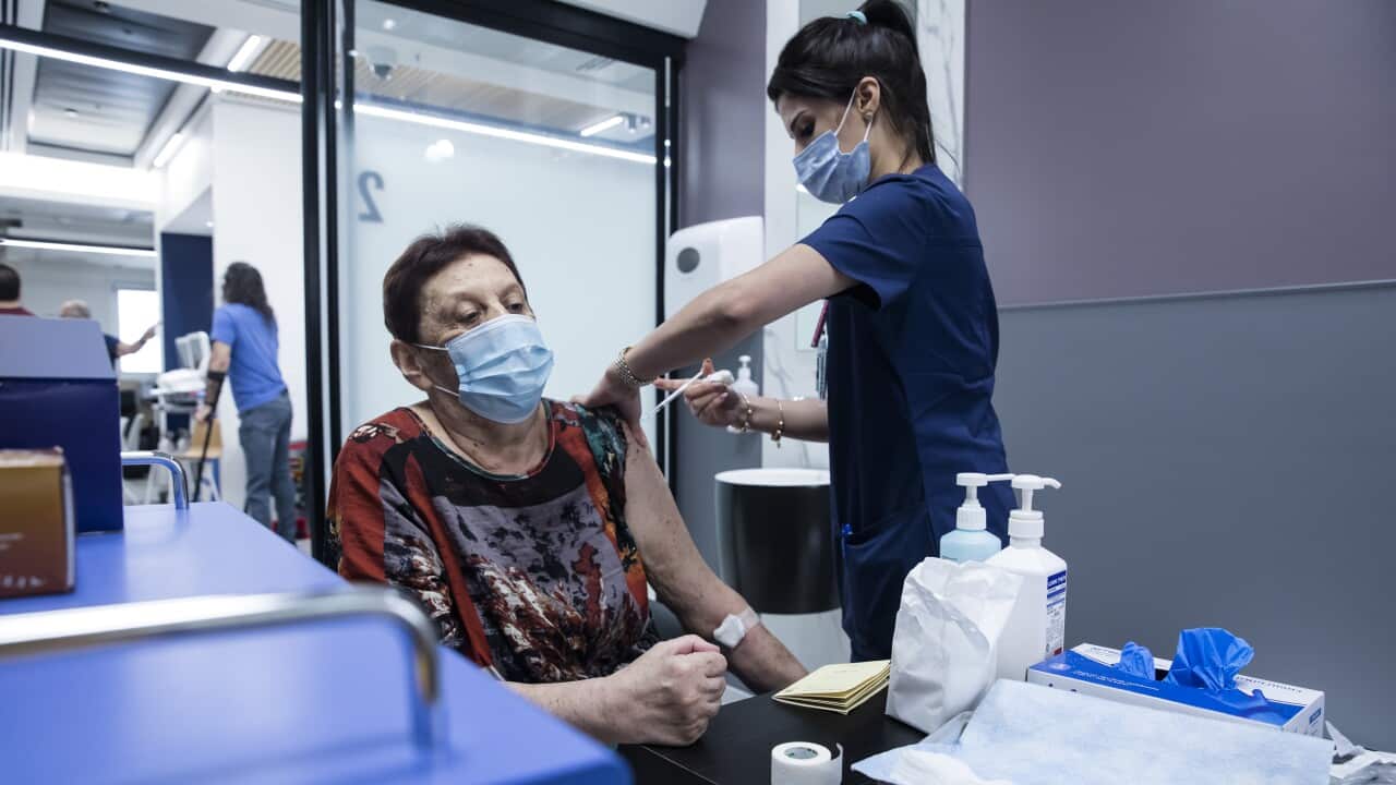 A woman receives her third dose of COVID-19 vaccine at Sheba Medical Centre in Ramat Gan, Israel.