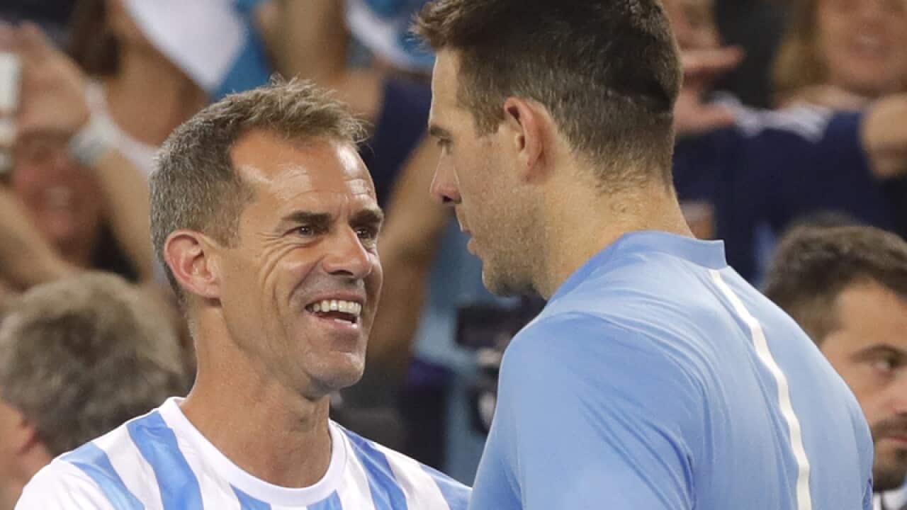 Argentinan Juan Martin del Potro celebrates with coach Daniel Orsanic