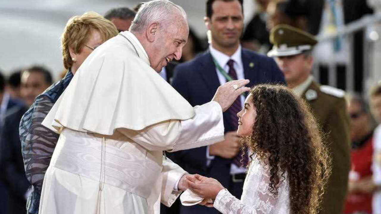 Pope Francis blesses a child