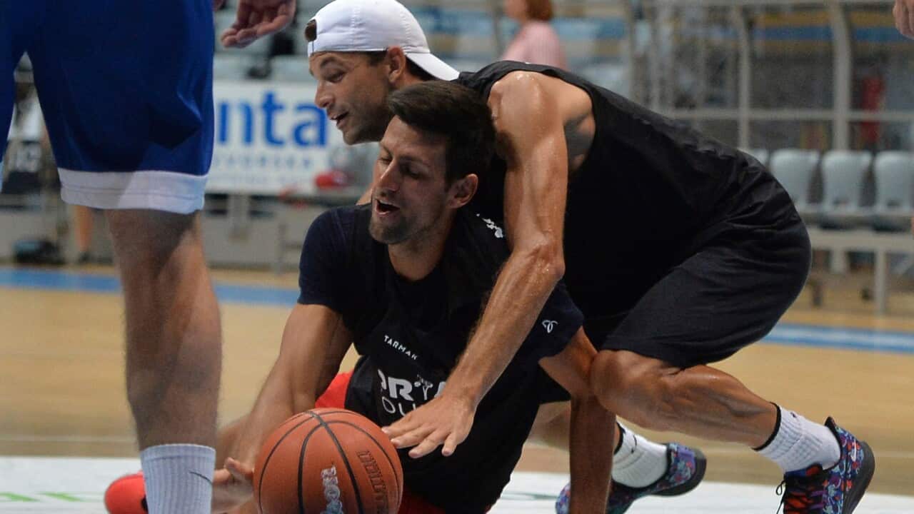 Bulgarian tennis player Grigor Dimitrov, rear, plays basketball with Serbia's Novak Djokovic in Zadar, Croatia