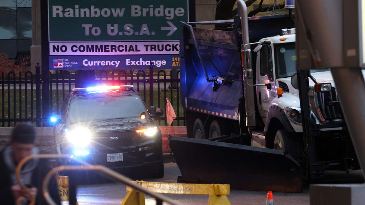 View of police car next to truck at Rainbow Bridge border crossing in Niagara Falls, following a car explosion.