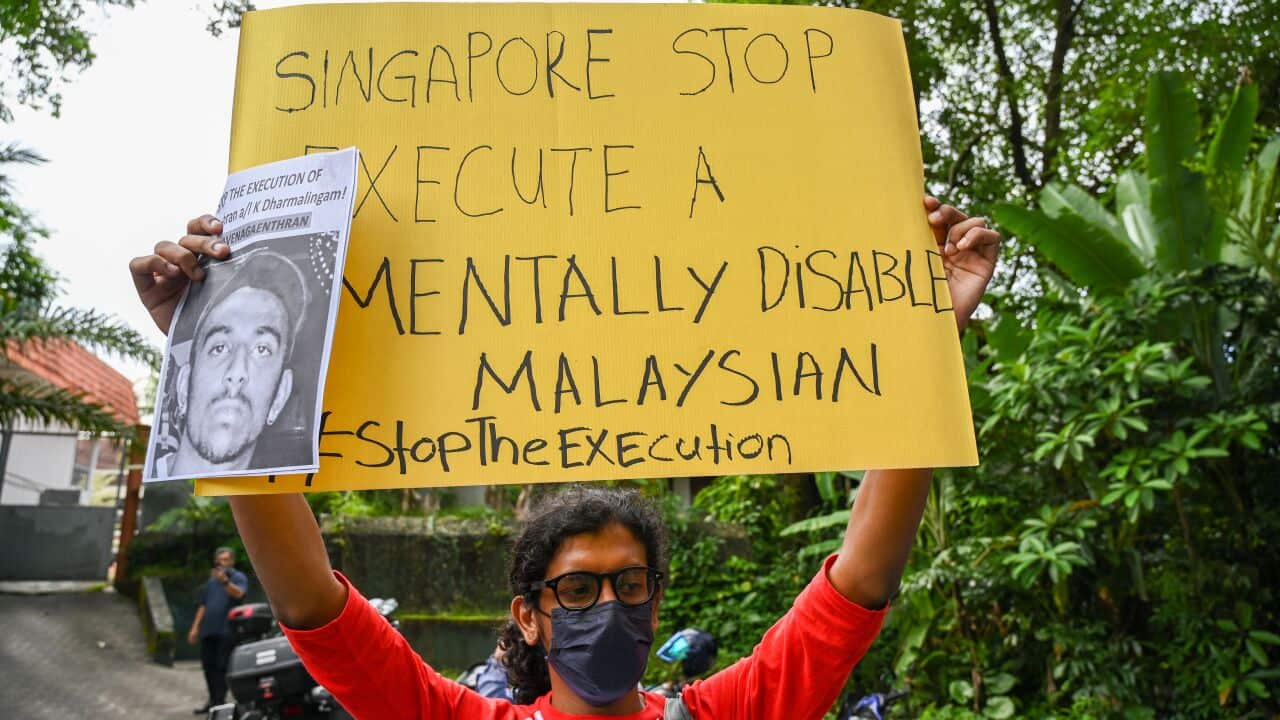 An activist in Kuala Lumpur holds a poster in protest of the execution of Nagaenthran K Dharmalingam.