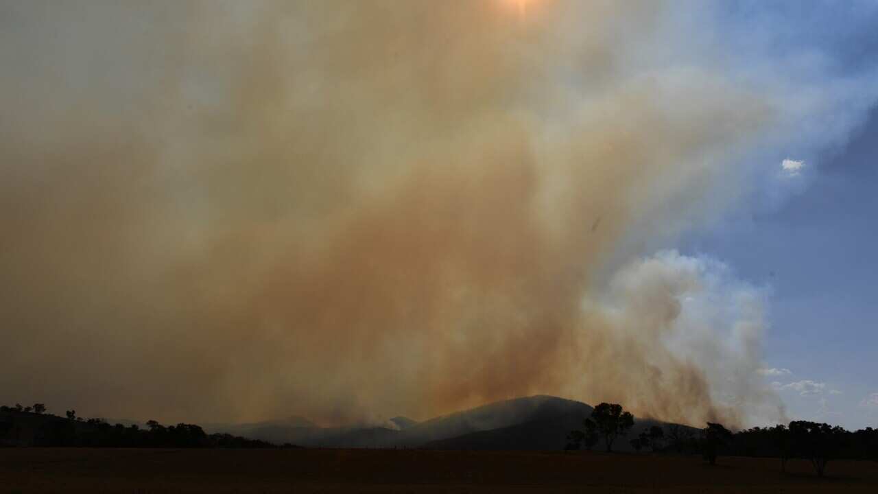 A bushfire burning south near the town of Tharwa, 30 kilometres south of Canberra.