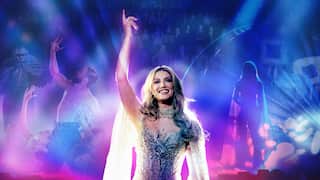 A woman wearing a sparkly dress with a purple background.