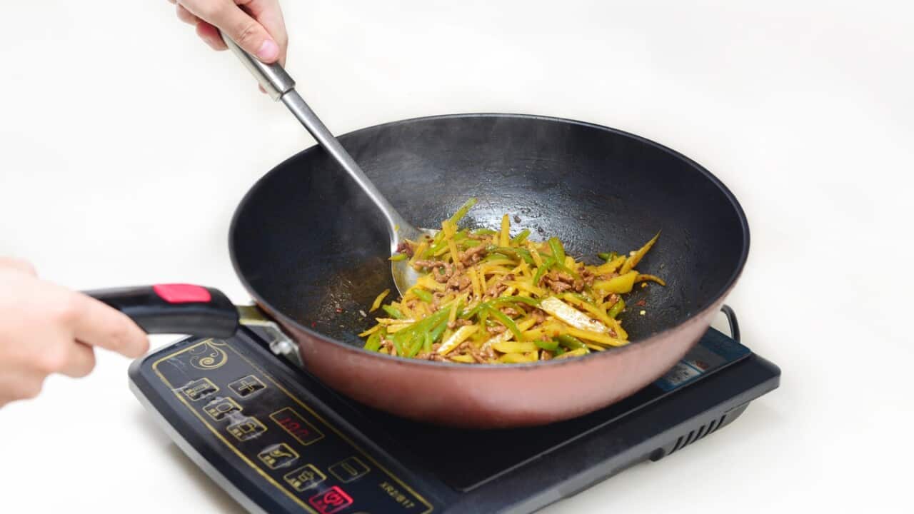 Cooking with a wok on an induction stove.