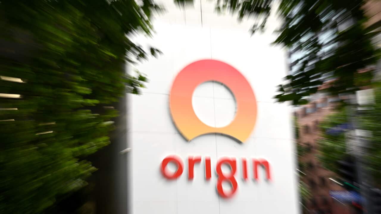 An Origin logo outside surrounded by trees.
