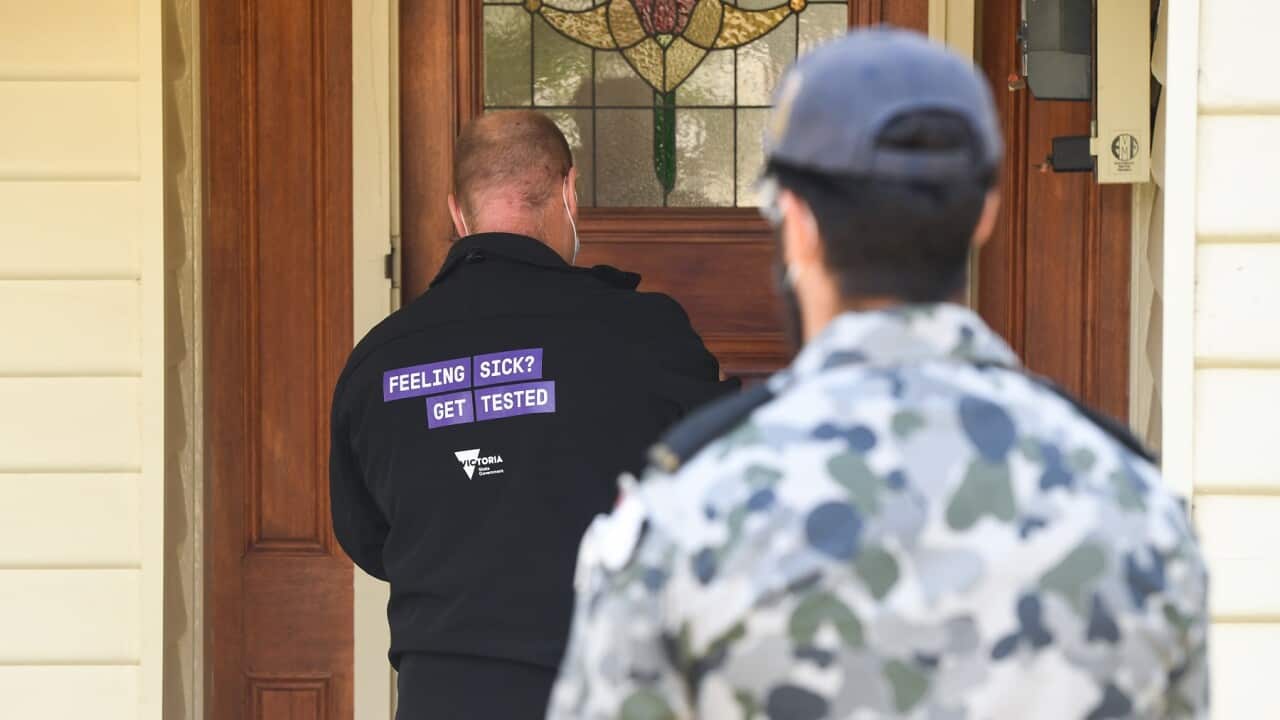 A government health official conducts a welfare check in Brunswick West, Melbourne (AAP)