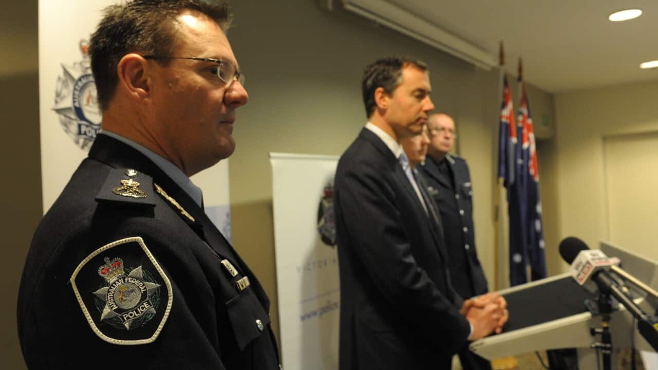 Federal Justice Minister Michael Keenan (centre) speaks in Geelong in 2014, while Australian Federal Police Deputy Commissioner Micheal Phelan looks on.