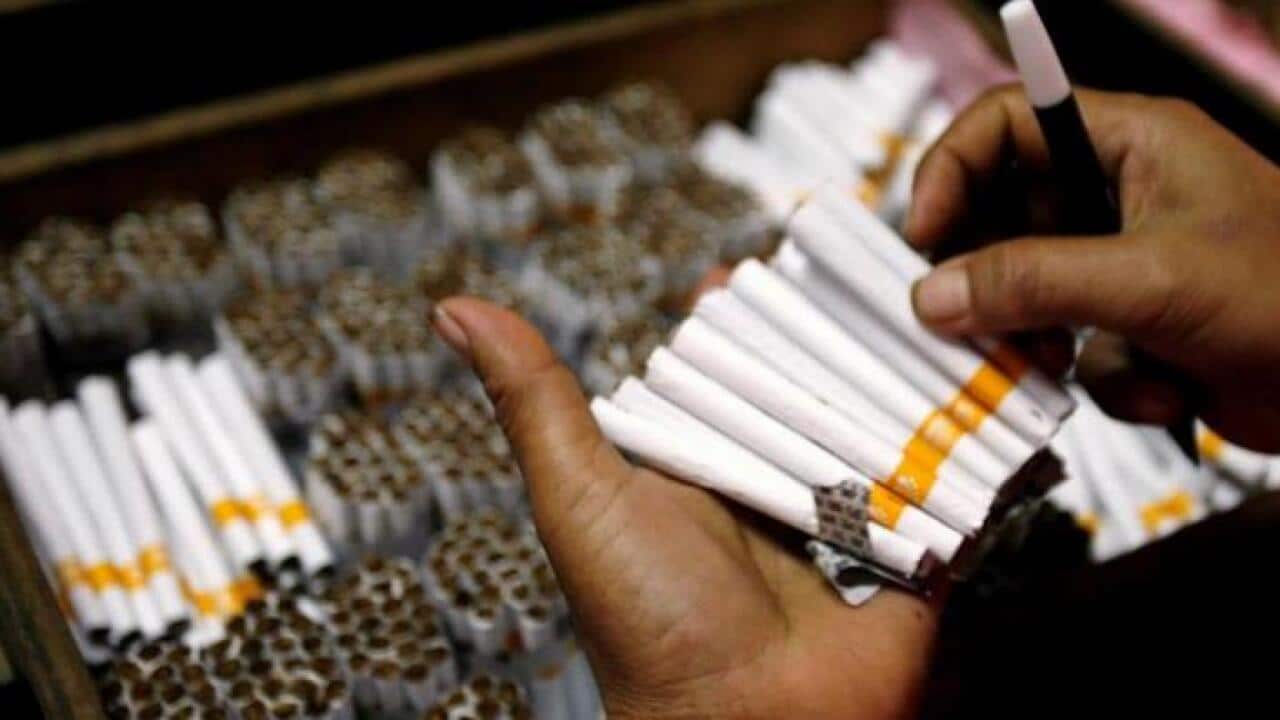 An employee counts cigarettes before packing them in Sidoarjo, Indonesia's East Java province April 7, 2010.