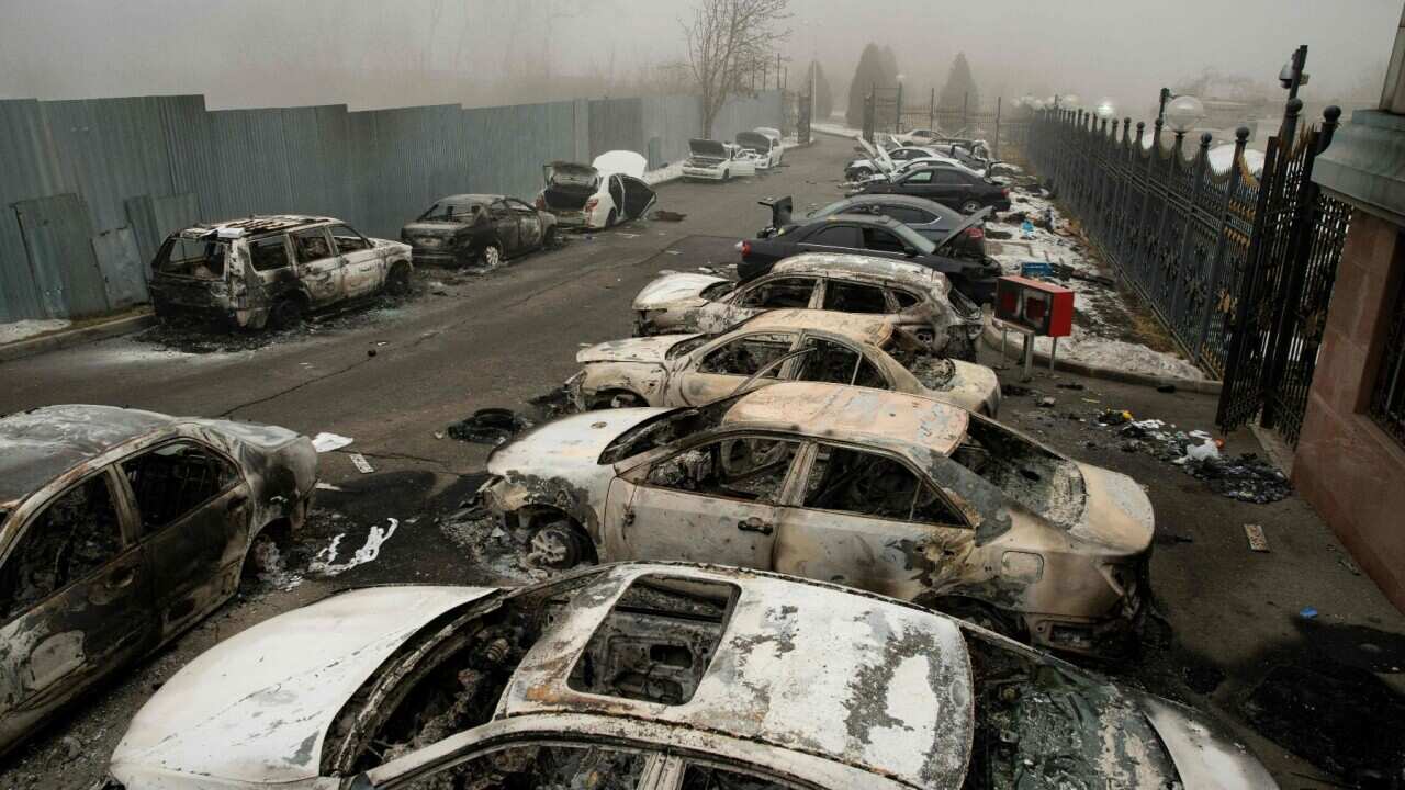 burnt-out cars in a parking area in central Almaty on January 6, 2022, after violence that erupted following protests over hikes in fuel prices.