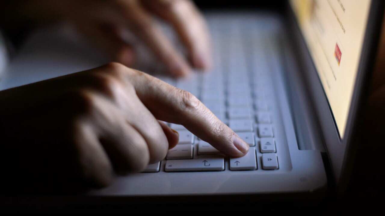 A woman's hands using a laptop keyboard