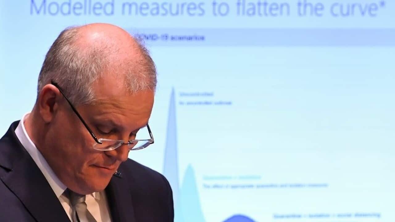 Australian Prime Minister Scott Morrison presents government modelling to reporters in Canberra.