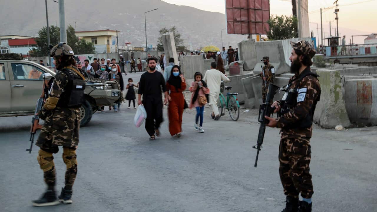 Taliban stand guard near the scene of a bomb blast in Kabul, Afghanistan, 3 October 2021.