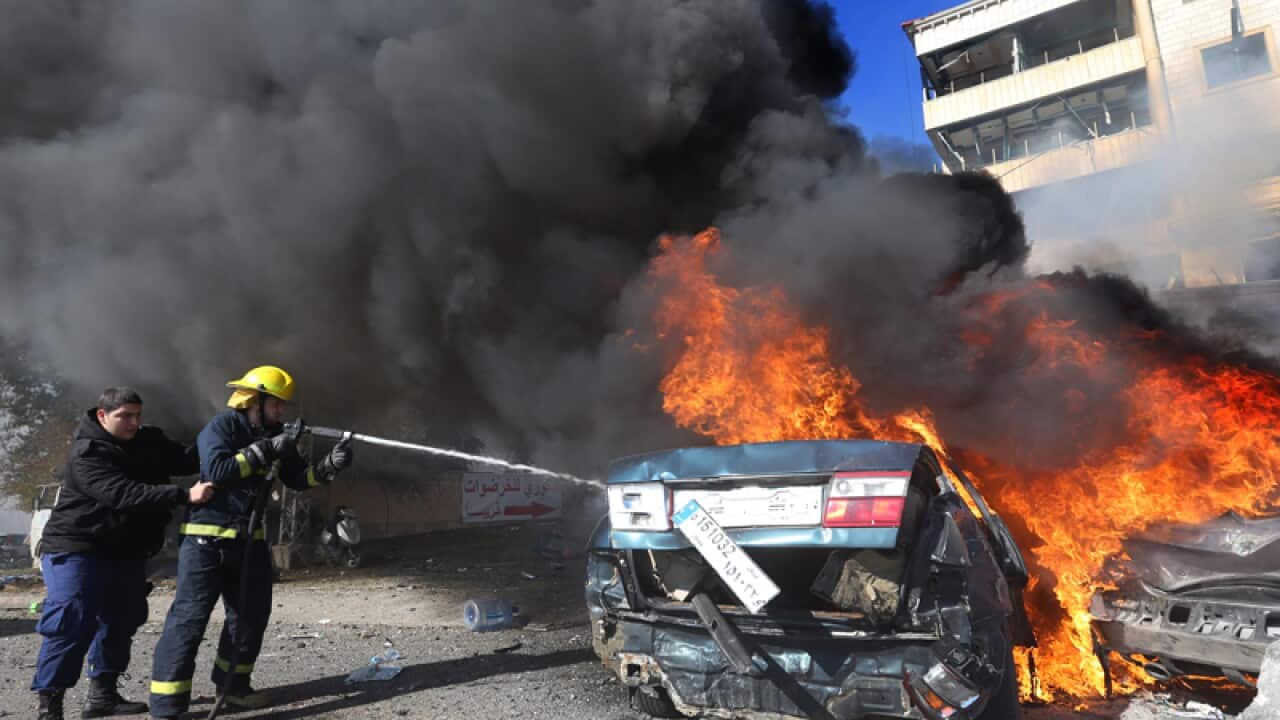 Lebanese firefighters at the site of an explosion in Beirut