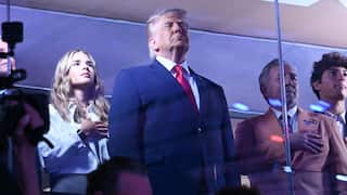 Trump standing in front of a few others in a box at Madison Square Garden