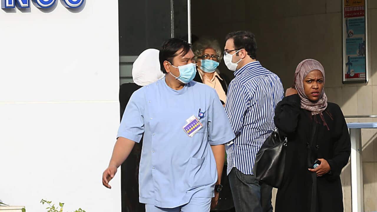 Medical workers wear face masks as they leave a local hospital