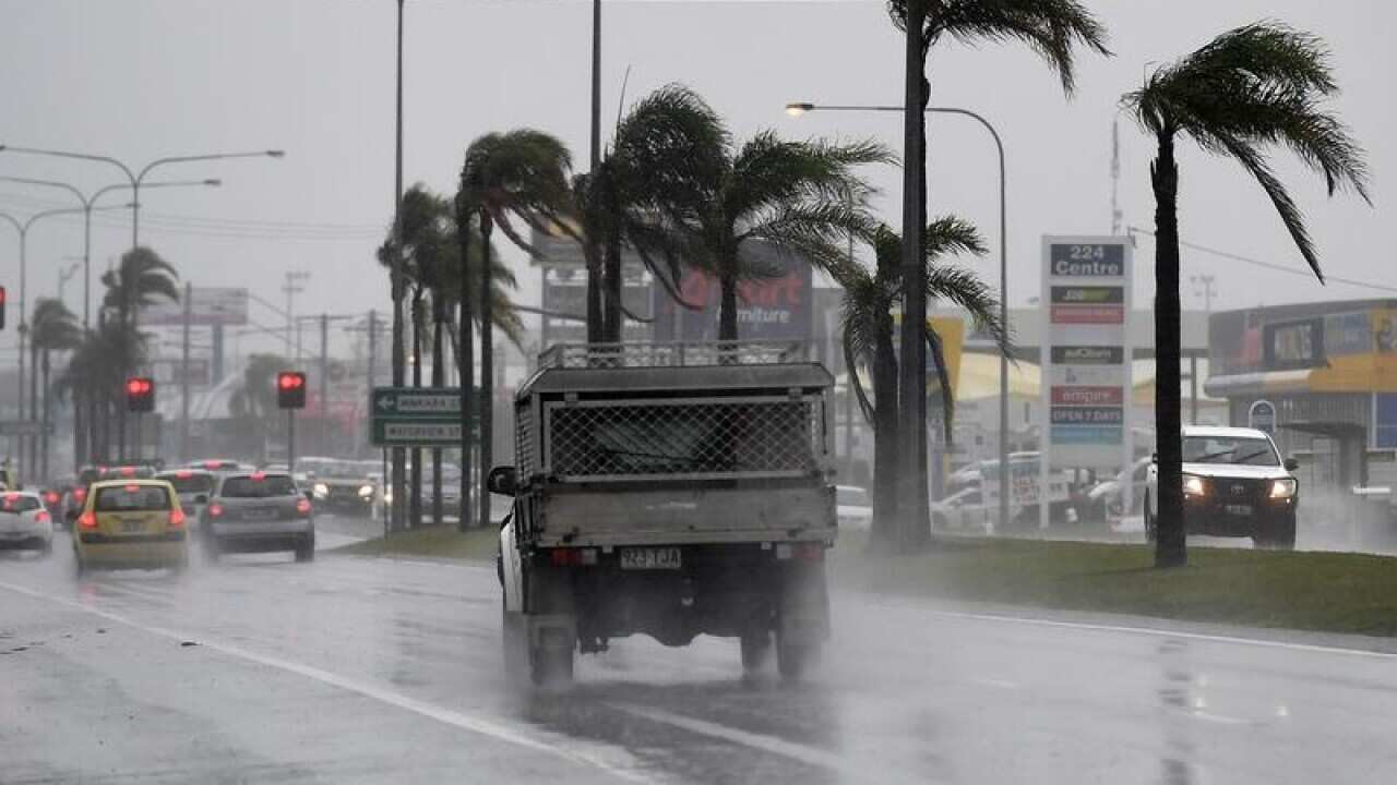 Drivers endure heavy rain and strong winds.