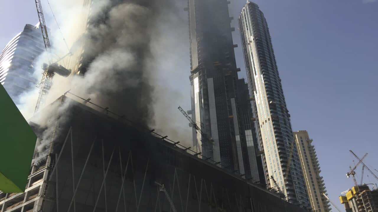 A fire rages at an under-construction tower in Dubai, United Arab Emiraes.