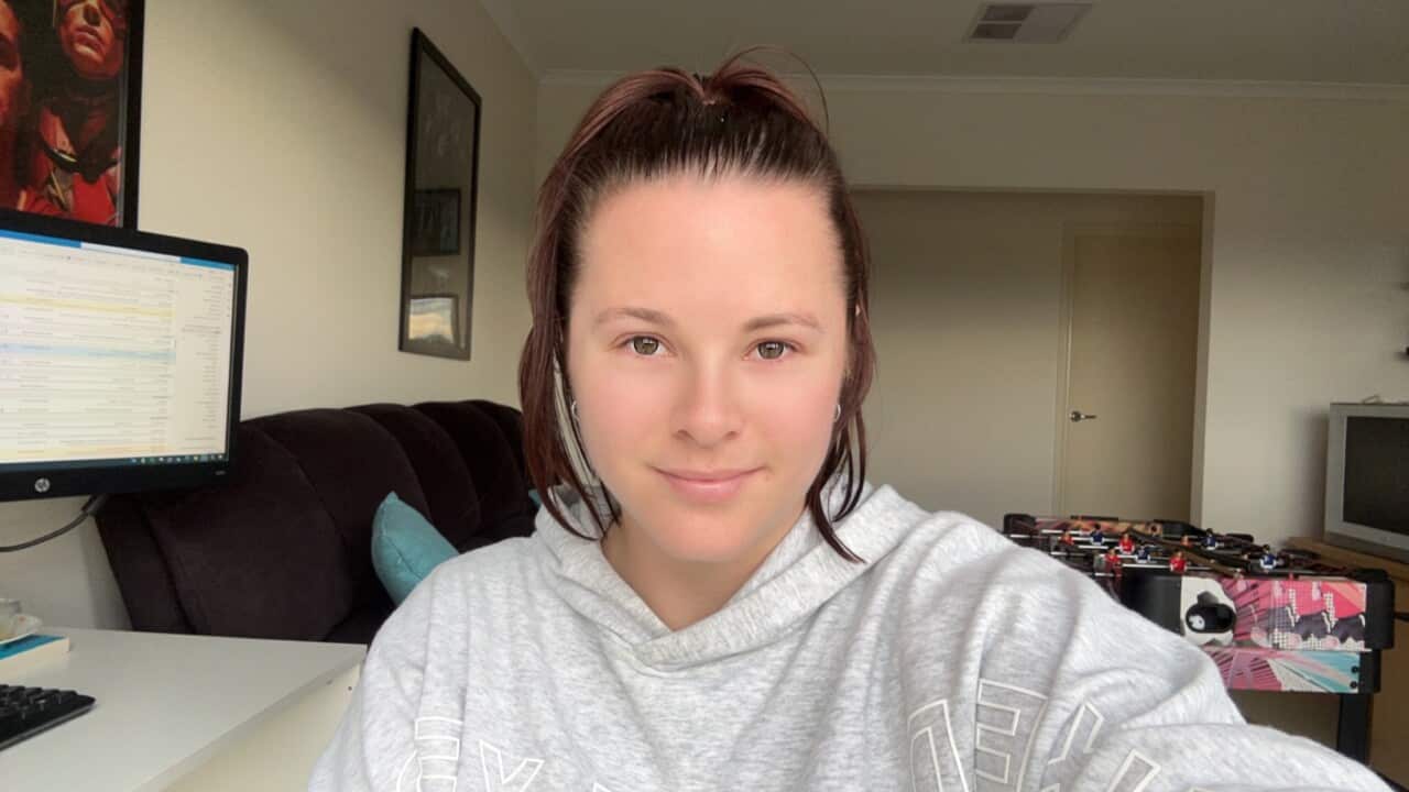 A photo of a woman looking at the camera.