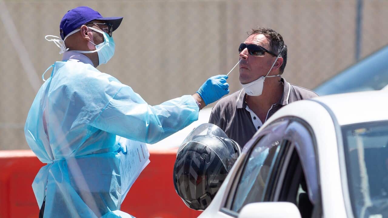 A member of the public has sample taken at a drive through covid testing site