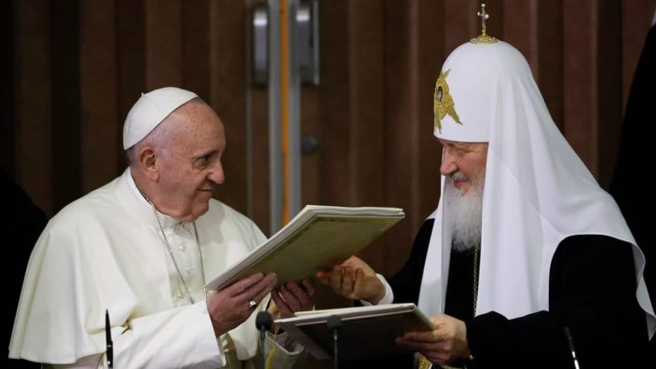 Pope Francis, left, and Russian Orthodox Patriarch Kirill exchange a joint declaration on religious unity