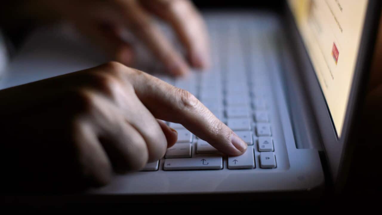 A woman uses a laptop