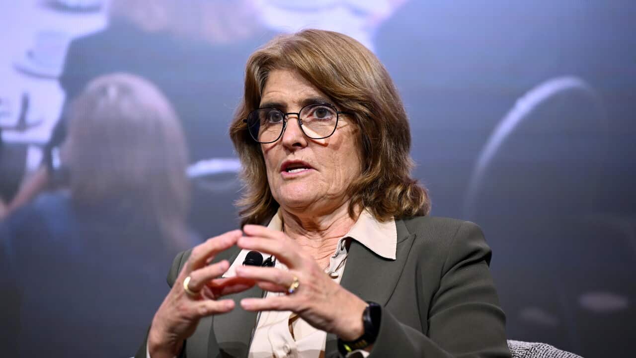 Reserve Bank governor Michele Bullock speaks during a public event, gesturing while seated on stage.