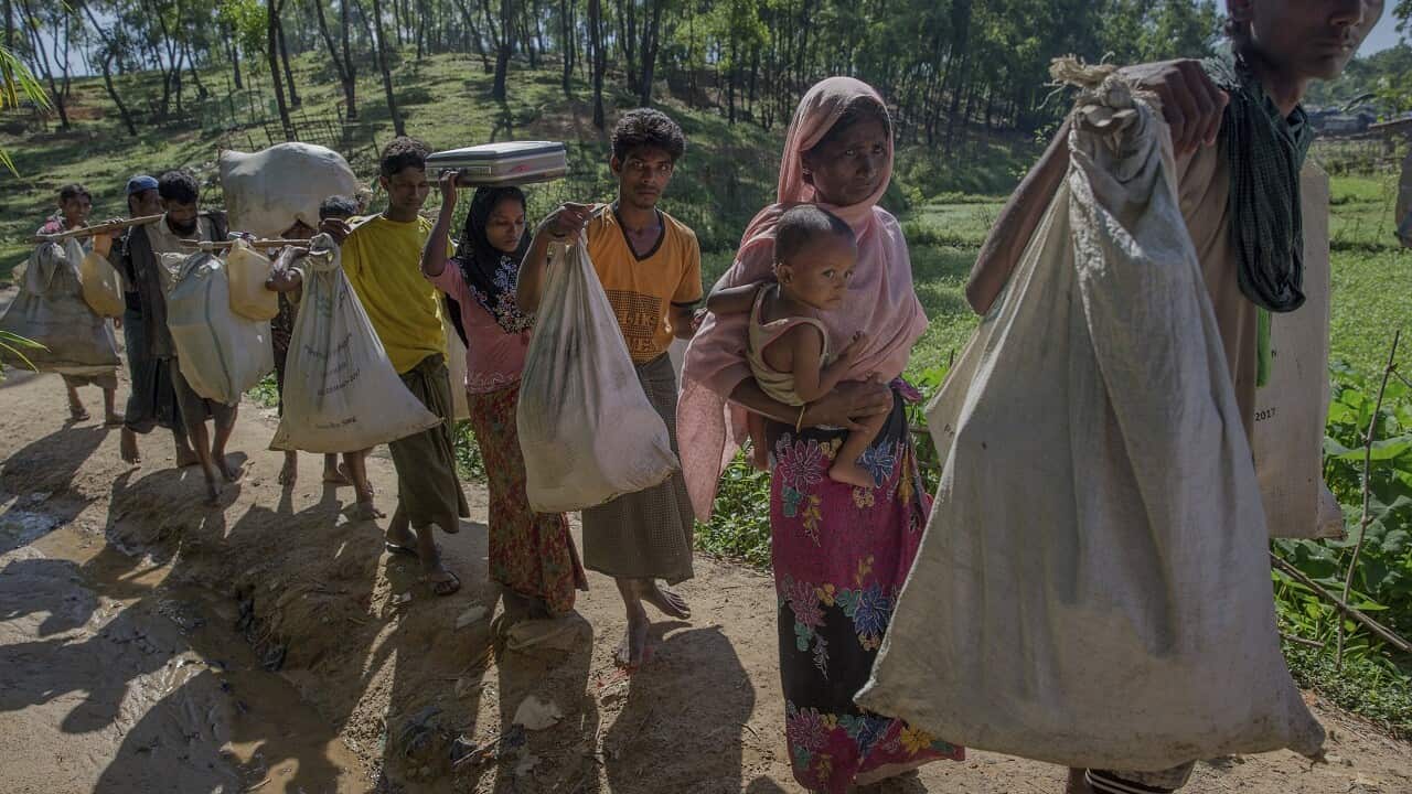 Newly arrived Rohingya Muslim family carry their belonging as they arrive at Kutupalong refugee camp, Bangladesh, Sunday, Sept. 24, 2017.