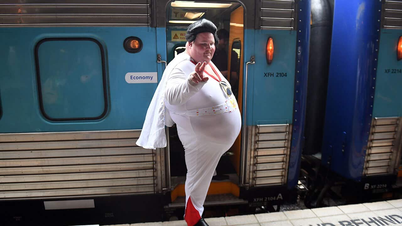 Elvis impersonator Sean Wright of Bowral poses for a photograph before boarding the Elvis Express at Central Station in Sydney.